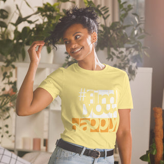 The Happy Channel® #FindYourHappy Unisex T-Shirt in Cornsilk Yellow, featuring bold white and orange text design, on female model.