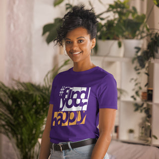 The Happy Channel® #FindYourHappy Unisex T-Shirt in Purple, featuring bold white and orange text design, on female model.