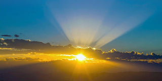 Golden sunrise breaking through clouds, symbolizing authenticity, clarity, and awakening to inner truth.