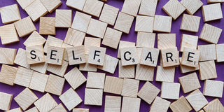 Scrabble Letters arranged to say "SELF CARE"