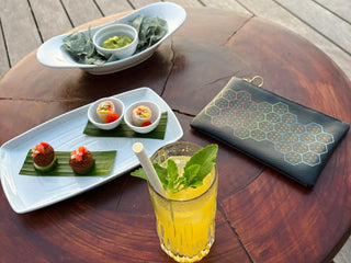 RUBY8WEAVER® Sweet Colors Designer Leather Clutch - Leather Clutch Bag - on wood table with non-alcoholic drink and vegetarian appetizers