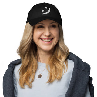 The Happy Channel® black dad hat featuring white embroidered smile logo on model