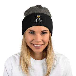 Woman wearing the dark heather grey and black Already Regis® Crowned Pom-Pom Beanie