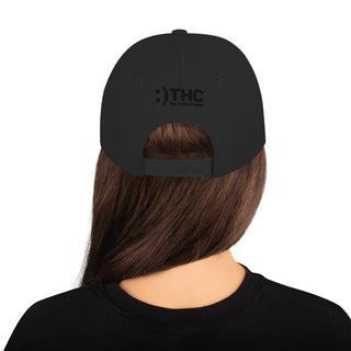 Back of black HA Snapback Hat with subtle The Happy Channel® embroidery